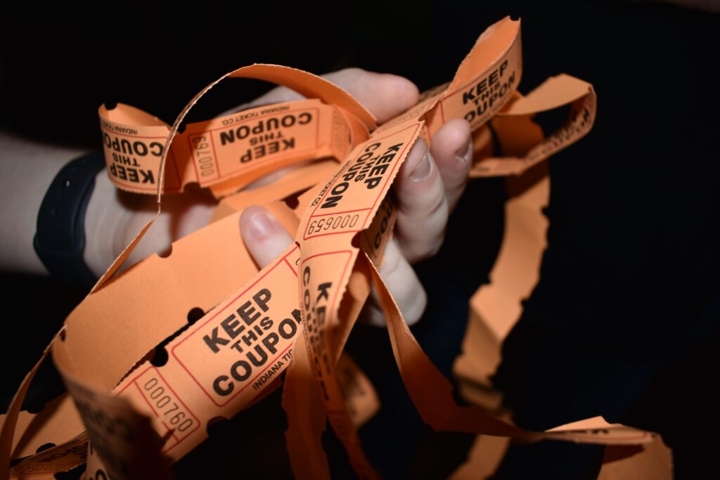 Image of person's hand holding raffle tickets